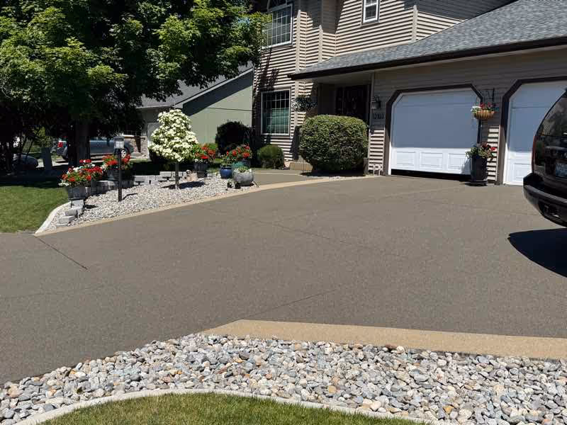 Resurfaced concrete driveway with a textured finish in front of a Spokane Valley garage