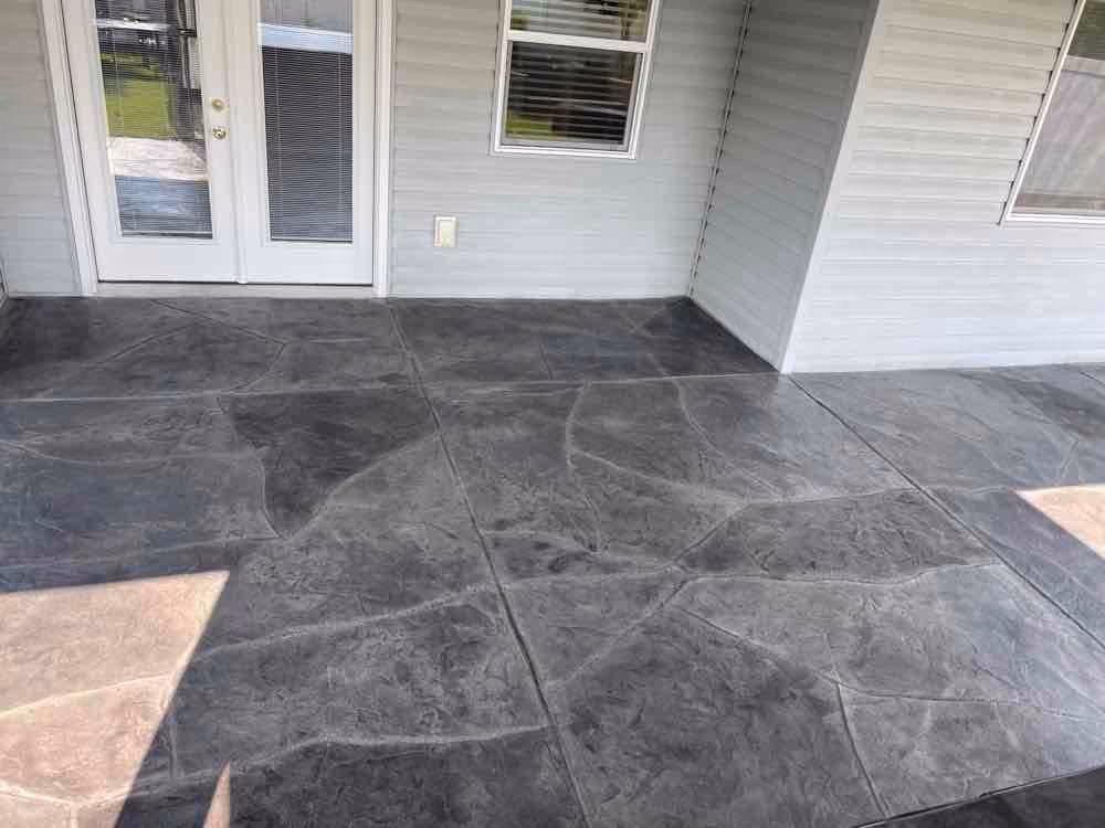 Resurfaced gray concrete patio beside a Spokane Valley home