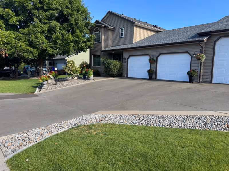 Resurfaced concrete driveway in front of a Spokane Valley home with three garages
